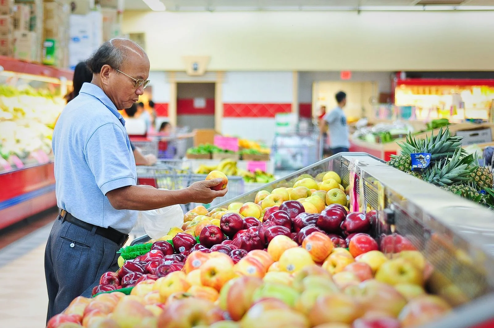 Shopper selecting produce at a market stall