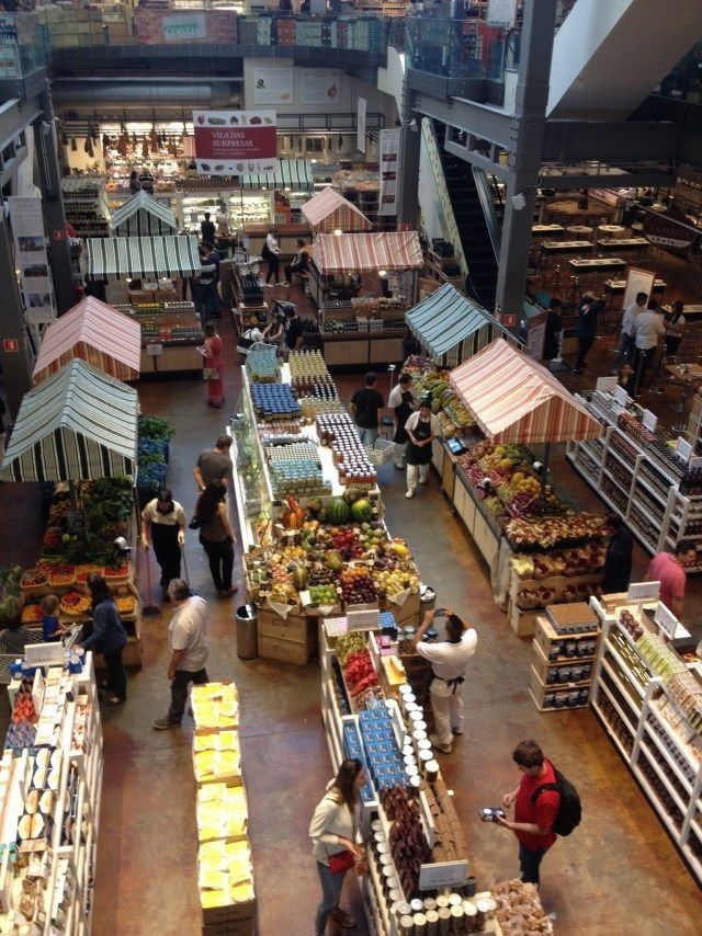 Indoor market hall with stalls and shoppers